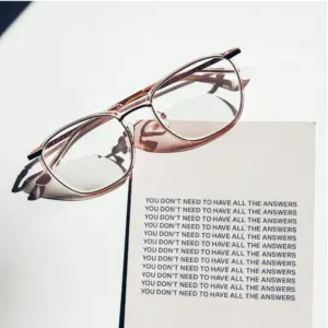 Glasses on a motivational text background
