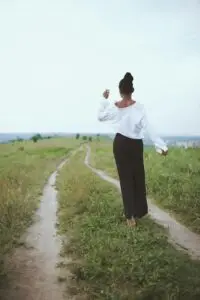 Woman walking on a grassy path